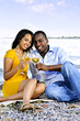 Happy couple having wine on beach