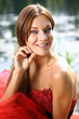 Portrait of a beautiful smiling woman in a red dress