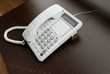 Photo: Telephone over brown desk Telephone over brown desk