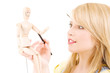 happy teenage girl with wooden model dummy