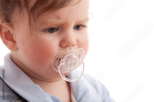 Photo: Portrait of displeased baby boy with pacifier Portrait of displeased baby boy with pacifier