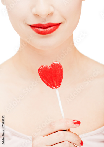 Photo: Girl holding a lollipop Girl holding a lollipop