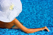 Woman with white hat in swimming pool