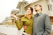 couple in  front of one-family house