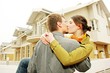 couple in  front of one-family house
