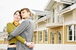 couple in  front of one-family house