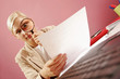 work environment- woman over some paperwork on pink