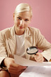 work environment- woman over some paperwork on pink