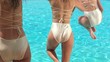 Girls jumping into the pool. PHANTOM HD Slowmotion shot
