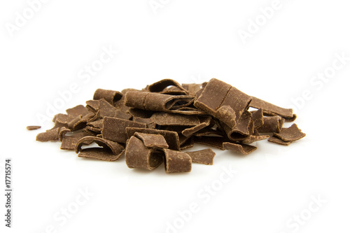 Photo: pile chocolate flakes over white background pile chocolate flakes over white background
