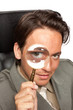 Young businessman with a magnifying glass Young businessman with a magnifying glass