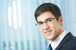 Portrait of happy smiling businessman at office