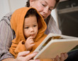 Grandmother Reading Book to Cute Grandson