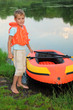 boy and inflatable boat ashore