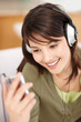 Cute young female hearing music from an mp3 player