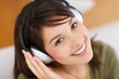 Portrait of a pretty teenager hearing  music on headphones