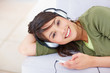 Cute female listening to music on  mp3 player