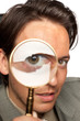 Young businessman with a magnifying glass Young businessman with a magnifying glass