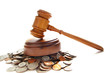 judges law gavel on a pile of coins, over white