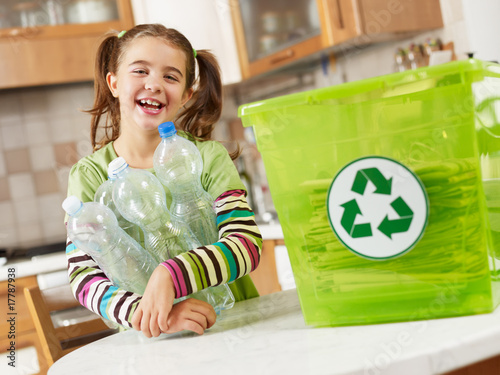 Photo: girl recycling plastic bottles girl recycling plastic bottles