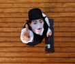 Portrait of the mime in a make-up on wood background