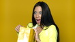 Sexy girl with shopping bag on yellow background
