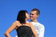 Enamoured pair outdoor under blue sky. Enamoured pair outdoor under blue sky.