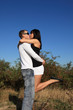 Playful young couple kissing outdoor. Playful young couple kissing outdoor.