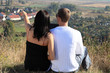 Foto: Loving couple sitting on a mountain. Loving couple sitting on a mountain.