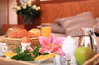 Tray with breakfast on a bed in a modern hotel room. Tray with breakfast on a bed in a modern hotel room.