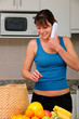 woman talking on phone while unpacking groceries