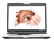 Eye looking through hole in screen of laptop Eye looking through hole in screen of laptop