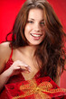 sexy girl smiles and holding a cgristmas gift in packing
