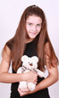 Backfisch in black gown and plush bear cub