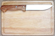 Sharp kitchen knife on wooden board