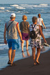 People walking in the surf on the beach People walking in the surf on the beach