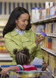 Woman with daughter in shopping cart at grocery store
