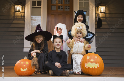 Photo: Children in Halloween costumes with pumpkins Children in Halloween costumes with pumpkins