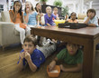 Children eating popcorn in livingroom