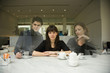 Woman at cafe with ghosted figures