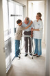 Young boy hugging grandfather at the corridor of a hospital