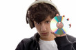 Teenage boy listening to music displaying CD