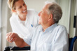 Senior man speaking to a nurse while at the hospital