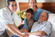 Portrait of a doctor shaking hands with a recovered elderly man