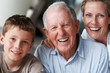 Old man laughing with daughter and grandson