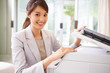 Happy business woman working on the photo copy machine Happy business woman working on the photo copy machine