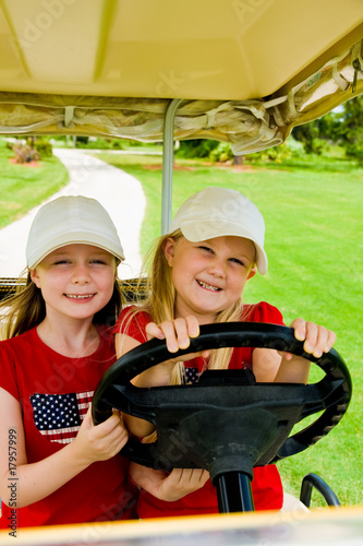 Photo: little sisters driving a golf cart little sisters driving a golf cart