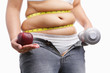 fat woman with unzup jeans holding apple and weight on each hand