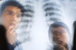 Asian doctor examining xray negative