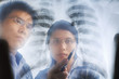 Asian doctors having discussion over xray print